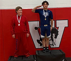 Two wrestling students standing on winners podium